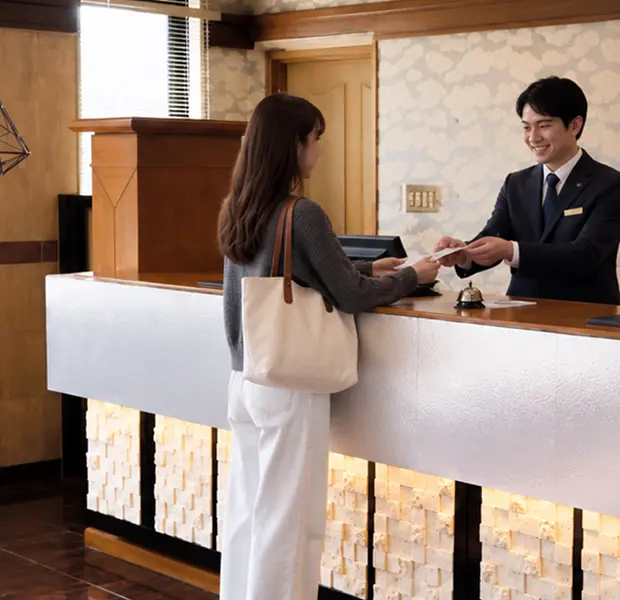 フロントでご案内をするスタッフと宿泊のお客様