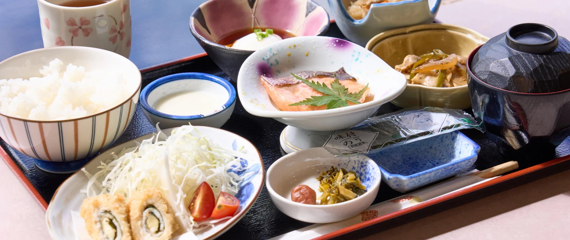 Japanese set breakfast with local ingredients (grilled fish, side dishes, rice and miso soup)